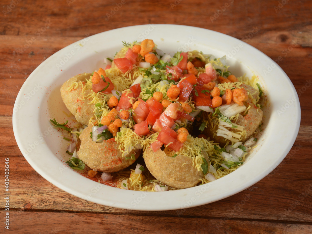 Masala puri is a famous midday snack in india, served over a rustic wooden background, selective focus Masala puri is a famous midday snack in india, served over a rustic wooden background, selective focus
