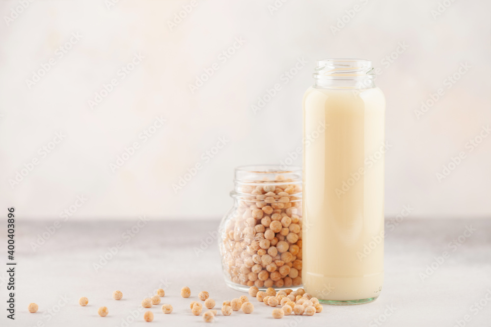 Vegetable pea milk in a bottle and peas in a jar. Gluten free, lactose free product Vegetable pea milk in a bottle and peas in a jar. Gluten free, lactose free product