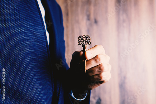 business concept man holding key in hand
