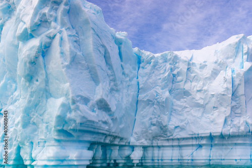 Amazing blue iceberg close up in Antarctica. Global warming.