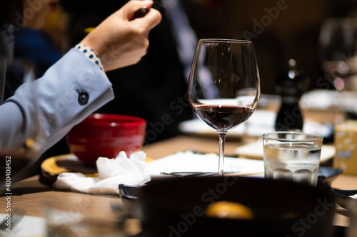 The wine glass was placed on the table in the restaurant at a dinner party