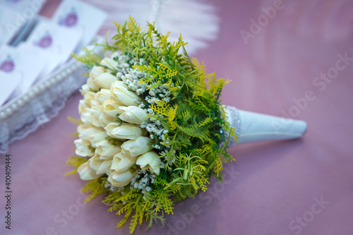 Freesia Single White . White wedding bouquet . vory and green wedding bouquet of roses and freesia flowers . Wedding bouquet made of white roses isolated on a white background . Freesia Koppert . photo