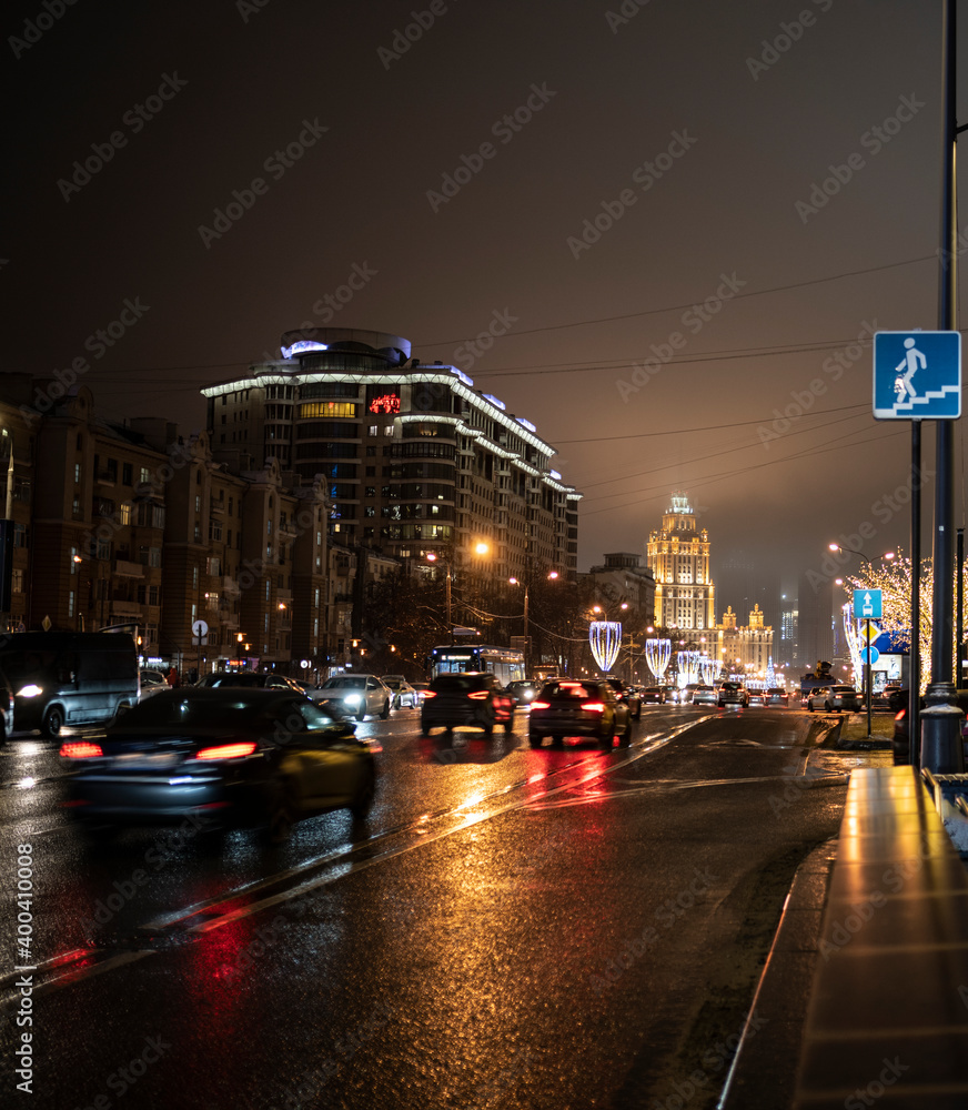 Fototapeta premium evening winter cityscape on the eve of the new year with dedicated buildings and illumination