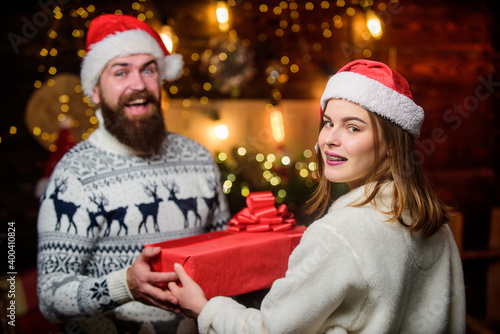 Generous Santa claus. Couple in love enjoy christmas holiday celebration. Family tradition. Surprise. Winter romance. Romantic feelings. Christmas time. Loving couple christmas tree background