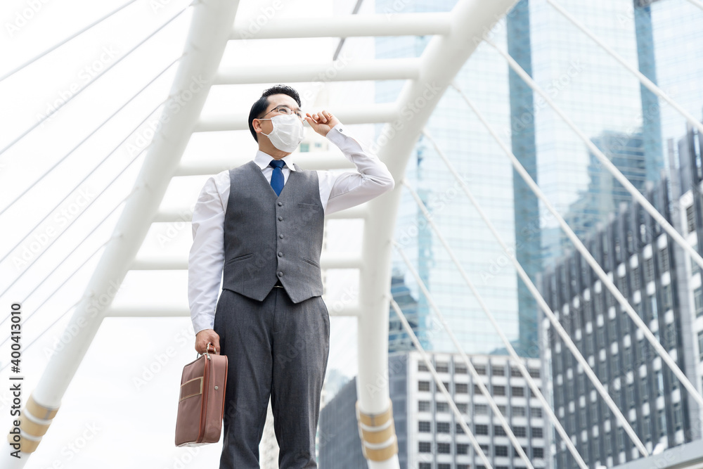 Portrait asian business man wearing protective face mask for protection during the quarantine Coronavirus covid 19 outbreak ,senior visionary executives leader with business vision