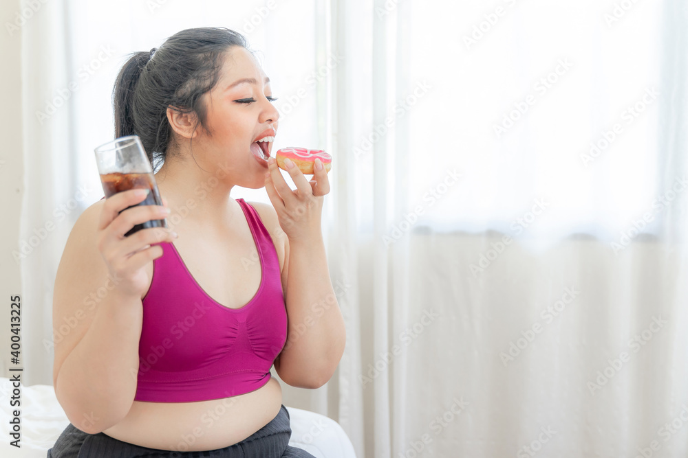 Portrait beautiful plump young asian woman joy of eating Junk food Sweet treat cake and Sweet water on bedroom reason why you are fat - lifestyle Woman diet weight loss overweigh Portrait beautiful plump young asian woman joy of eating Junk food Sweet treat cake and Sweet water on bedroom reason why you are fat - lifestyle Woman diet weight loss overweigh