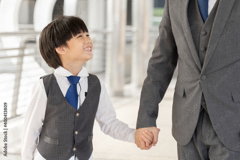 Son holding father's hand on business district urban, Dad and Son happy Asian family concept Son holding father's hand on business district urban, Dad and Son happy Asian family concept