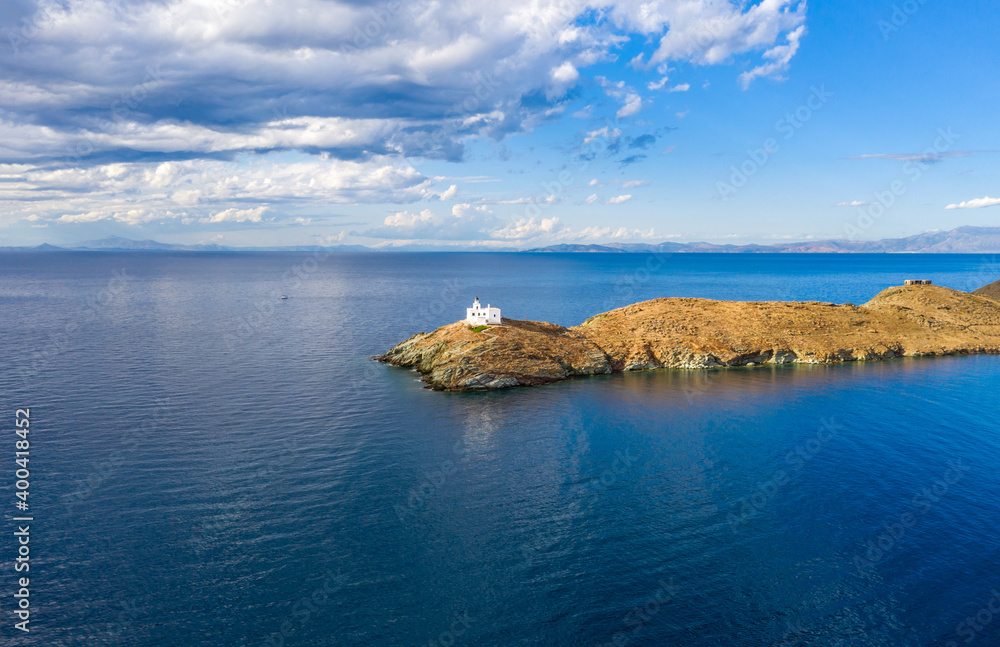 Greece, Kea Tzia island. Lighthouse on rocky cape, sky, sea background.