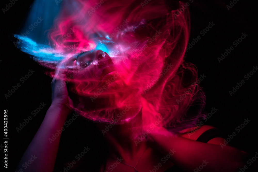 Girl, model photographed on a long exposure in the studio with color filters. Portrait Girl, model photographed on a long exposure in the studio with color filters. Portrait