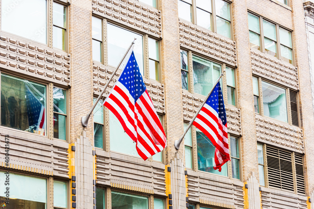 American Flags waving on building.