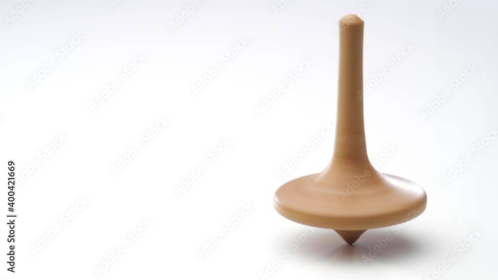 Close up shot of a wooden spinning top moving. Close up shot of a wooden spinning top moving.