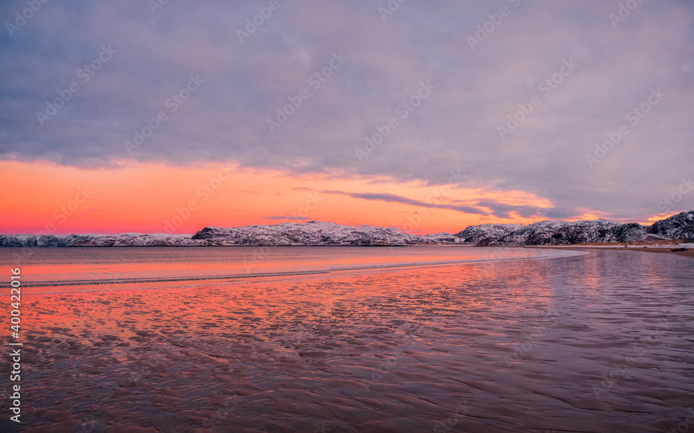 Fototapeta premium Amazing sunrise polar landscape with white snowy mountain range on the horizon. Arctic ocean panoramic view
