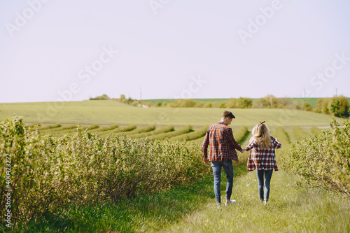 Man and woman in a field on spring day. Couple in love spend time in spring field. Grass on background.