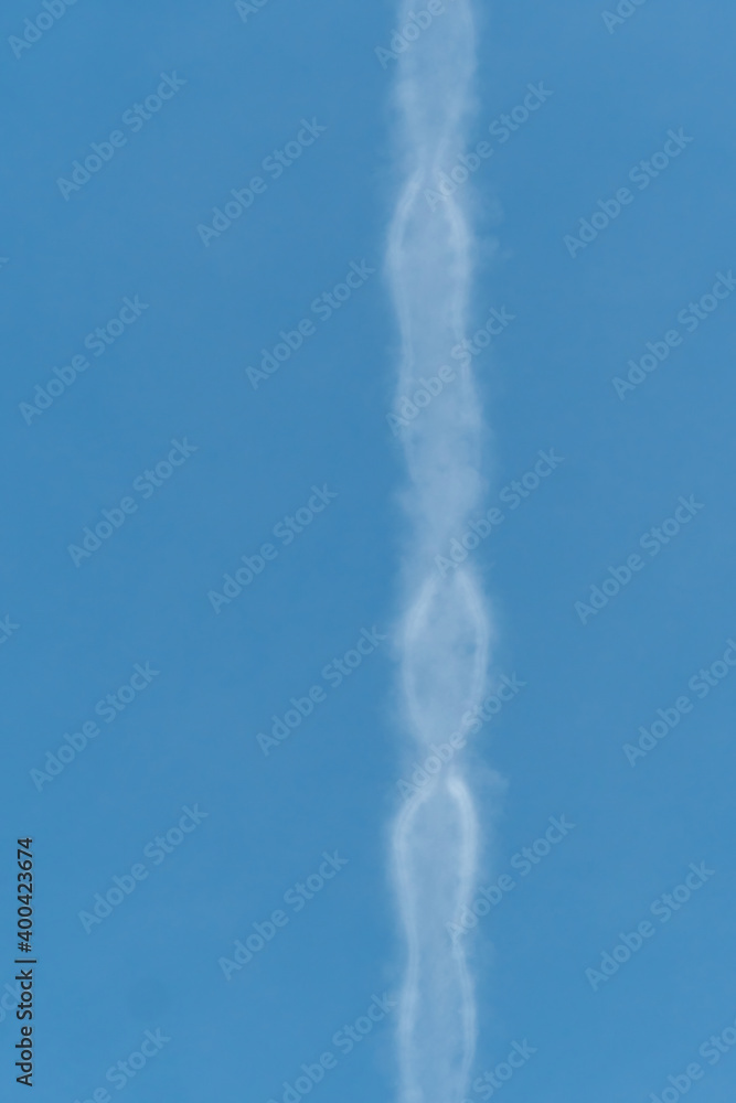 smoke with an interesting shape leftover by the passing plane on the clear blue sky smoke with an interesting shape leftover by the passing plane on the clear blue sky