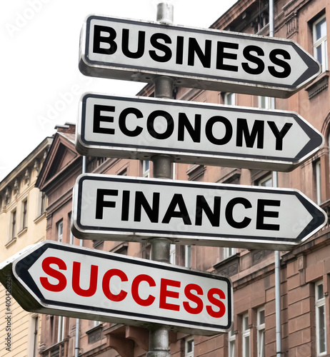 The road indicator on the arrows of which is written - business, economics, finance and SUCCESS
