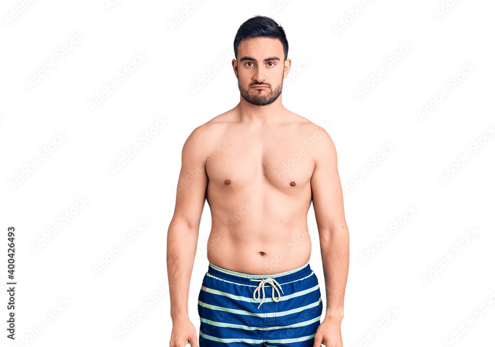 Young handsome man wearing swimwear depressed and worry for distress, crying angry and afraid. sad expression. Young handsome man wearing swimwear depressed and worry for distress, crying angry and afraid. sad expression.