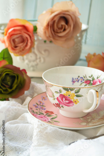 Still life with a bouquet of vintage rose flowers and tea cup