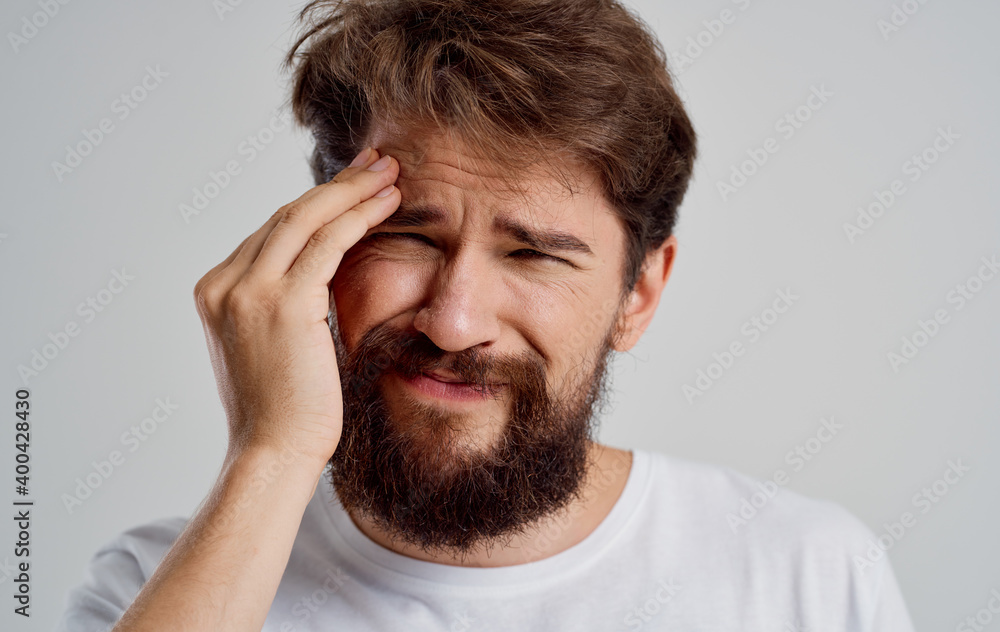bearded man holding his head discontent health problem disorder bearded man holding his head discontent health problem disorder