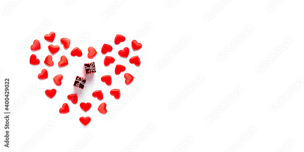 Two red gifts lie in hearts on a white background. Valentine's Day concept, banner, flat lay