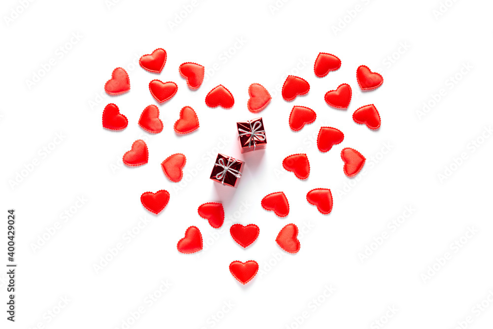 Two red gifts lie in hearts on a white background. Valentine's Day concept, flat lay