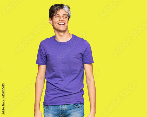 Young hispanic man wearing casual clothes looking positive and happy standing and smiling with a confident smile showing teeth