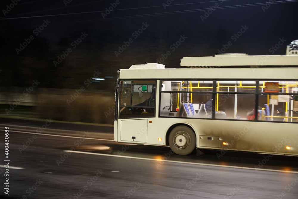 Dirty bus rushes along the night highway