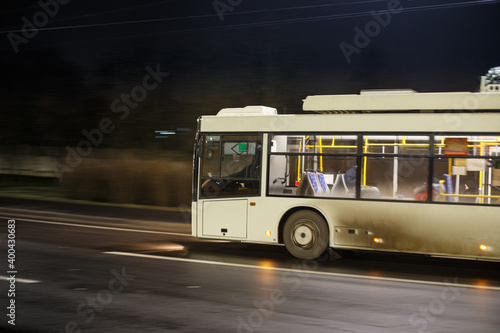 Dirty bus rushes along the night highway