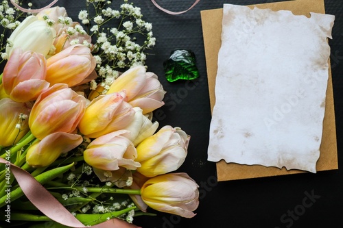 postcard layout. large bouquet of yellow tulips on a black background photo