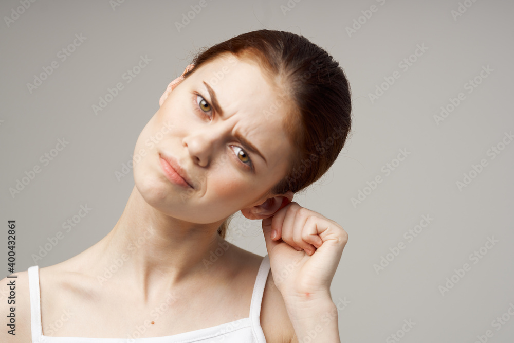 disgruntled woman holding her ear health problems close-up disgruntled woman holding her ear health problems close-up