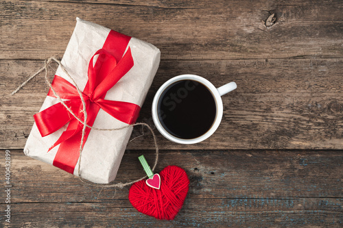 February 14, heart, gift and coffee on a wooden background. Top view, with space to copy. The concept of Valentine's Day.