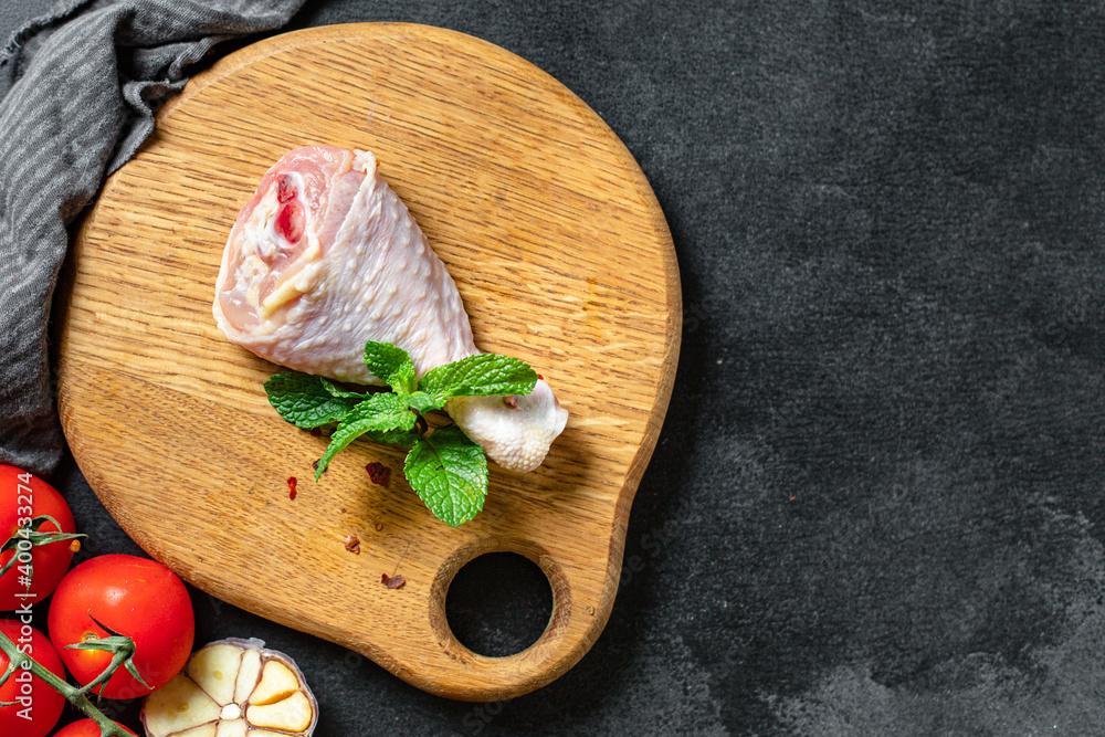 Chicken leg meat raw skin bones broiler fresh piece on the table healthy meal ingredient top view copy space for text food background rustic image Chicken leg meat raw skin bones broiler fresh piece on the table healthy meal ingredient top view copy space for text food background rustic image
