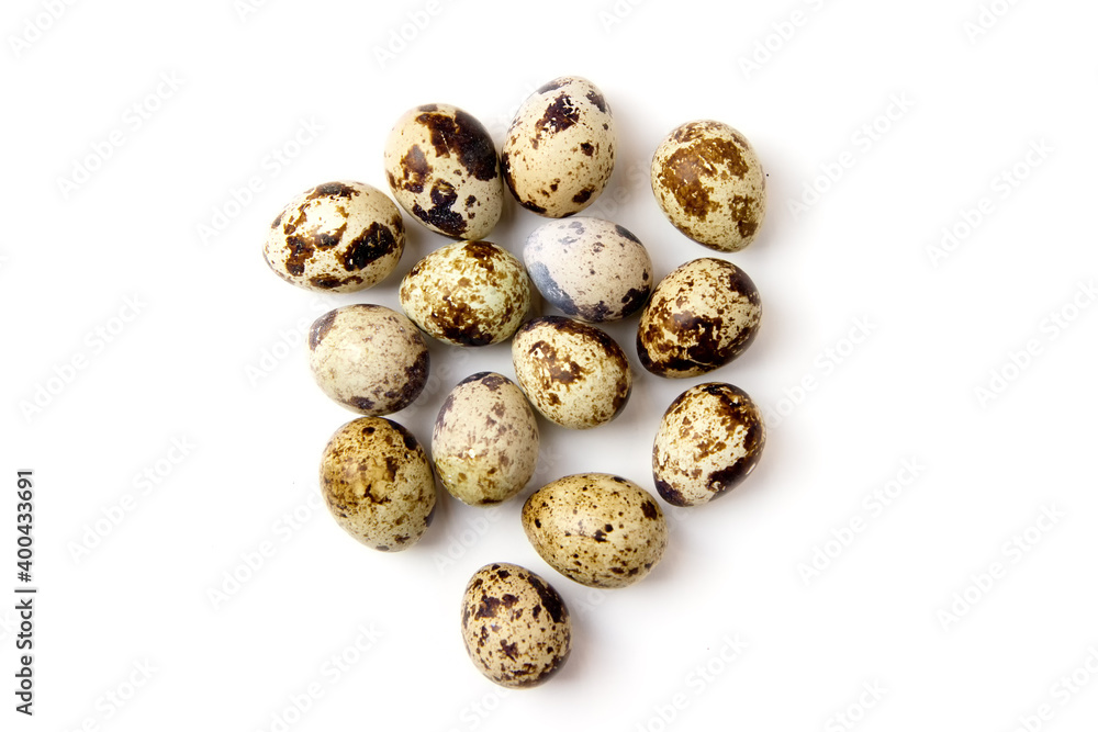 Uncooked scattered Quail eggs on white background top view, healthy food