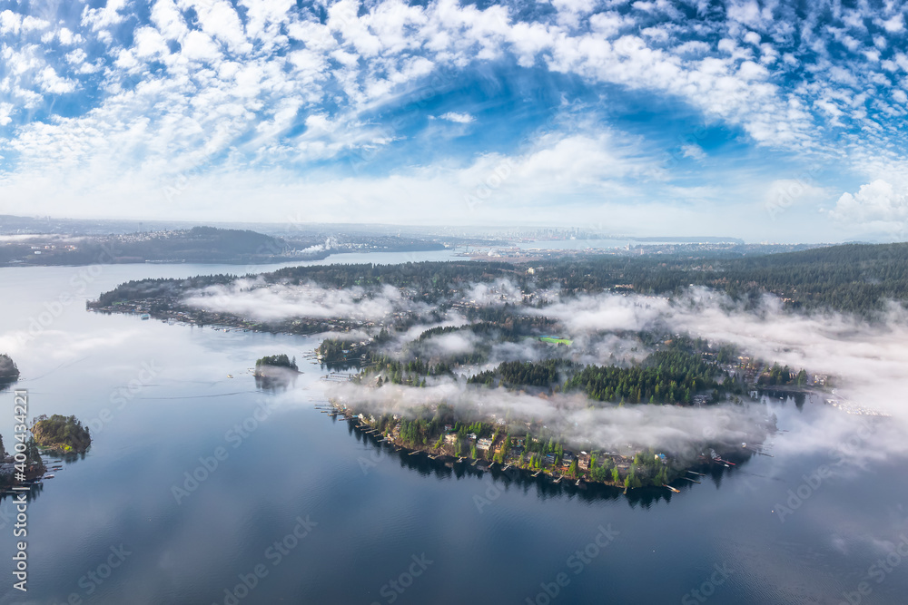 Deep Cove, Greater Vancouver, British Columbia, Canada. Beautiful view on the luxury homes in a modern city covered in fog. Colorful Sunny Morning Sky.