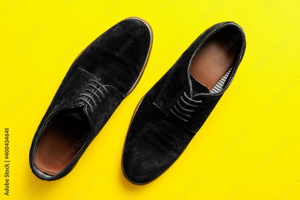 Classic leather male shoes on color background