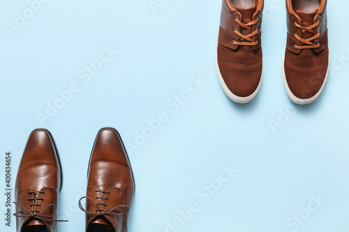 Different male shoes on color background