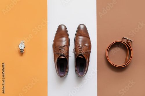 Classic leather male shoes on color background