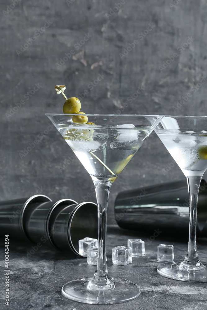 Glasses of tasty martini with olives on grunge background Glasses of tasty martini with olives on grunge background