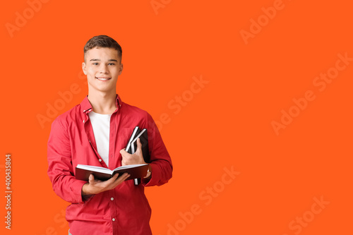 Teenage boy with books on c...