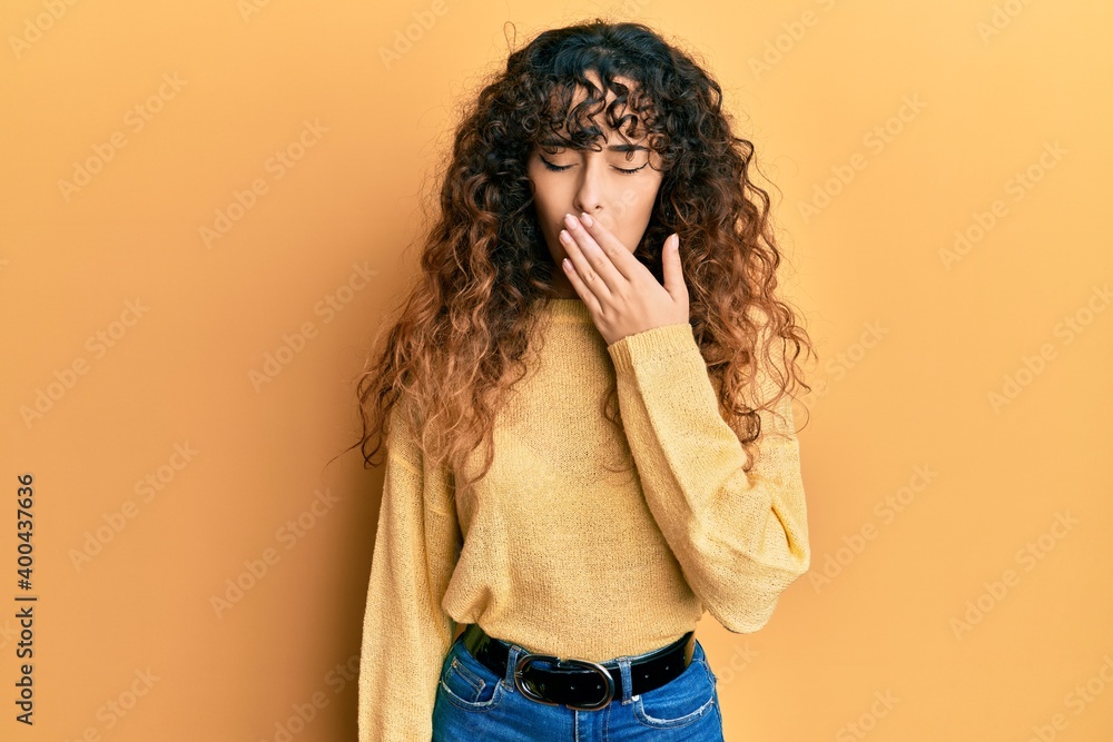 Young hispanic girl wearing casual clothes bored yawning tired covering mouth with hand. restless and sleepiness. Young hispanic girl wearing casual clothes bored yawning tired covering mouth with hand. restless and sleepiness.