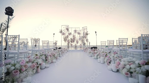Decor for a wedding on the background of the sea. Arches of flowers at the beginning of the wedding path.
