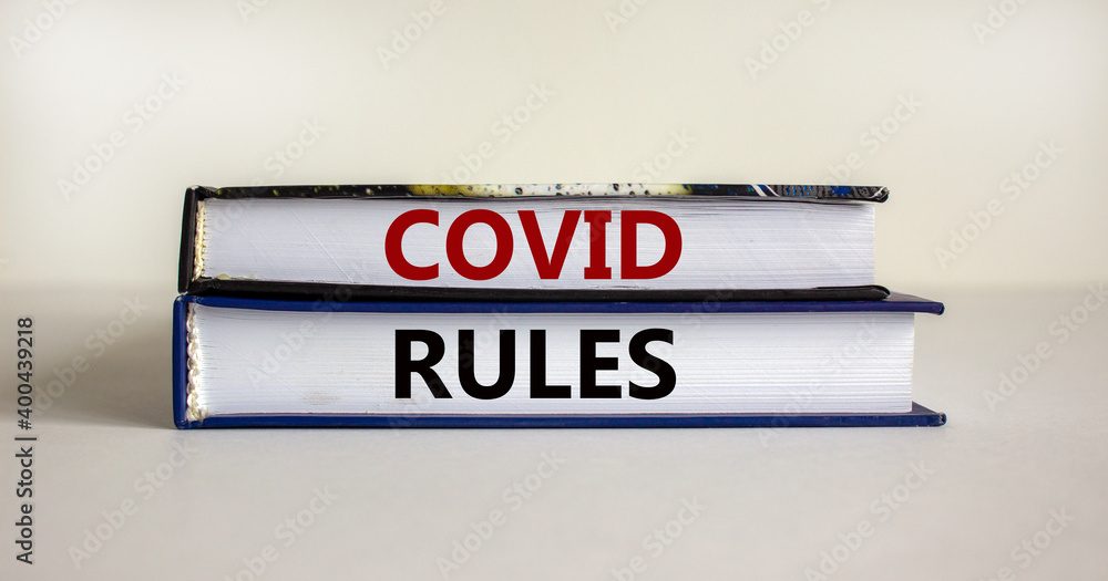 Covid rules symbol. Books with text 'covid rules' on beautiful white background. Covid-19 pandemic and covid rules concept, copy space.