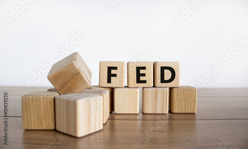 FED symbol. Wooden cubes with word 'FED' on a beautiful wooden table, white background. Business and FED concept, copy space.