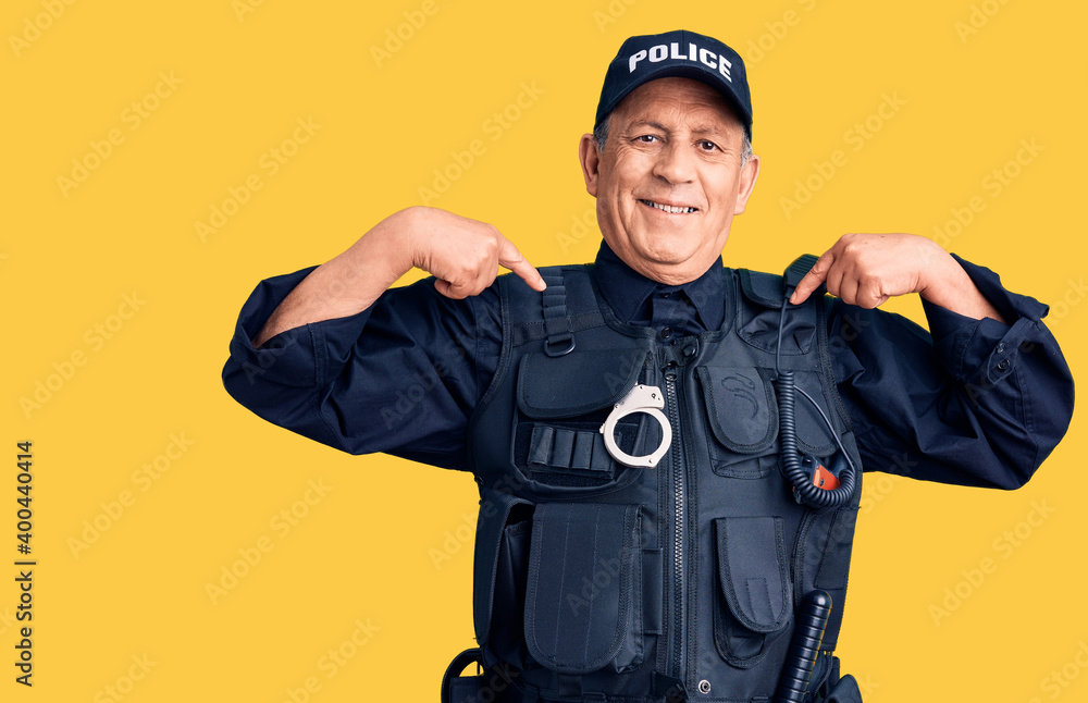 Senior handsome man wearing police uniform looking confident with smile on face, pointing oneself with fingers proud and happy. Senior handsome man wearing police uniform looking confident with smile on face, pointing oneself with fingers proud and happy.
