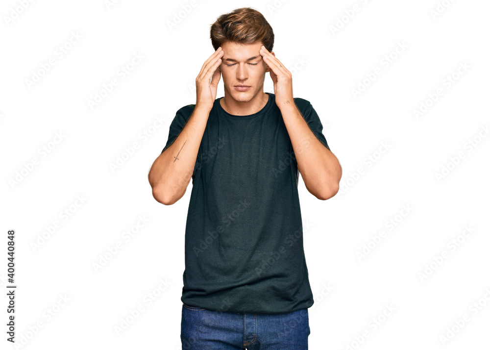 Handsome caucasian man wearing casual clothes with hand on head for pain in head because stress. suffering migraine. Handsome caucasian man wearing casual clothes with hand on head for pain in head because stress. suffering migraine.