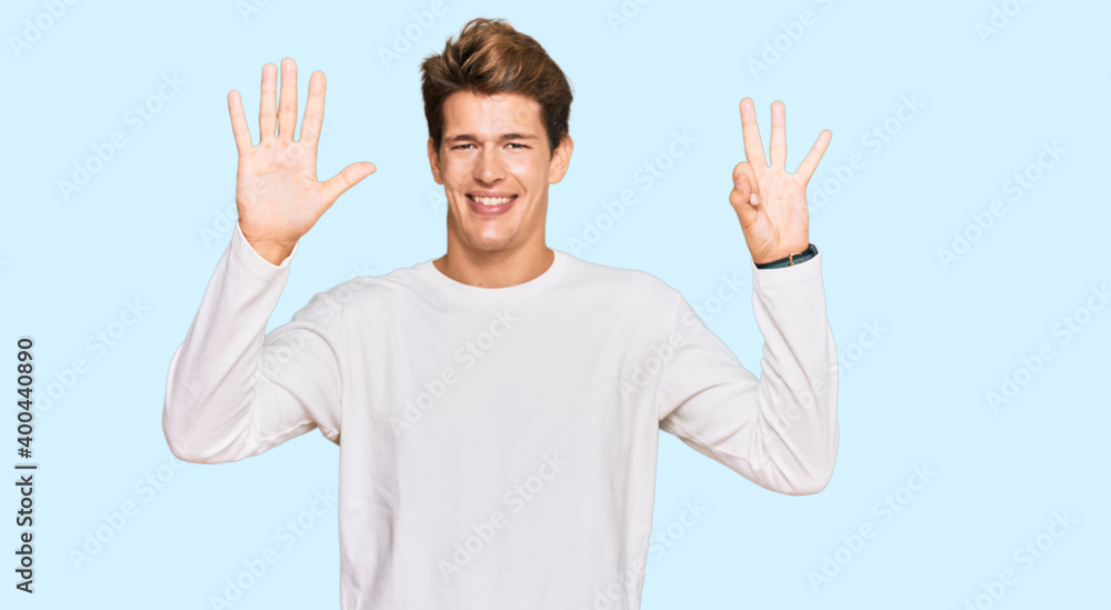 Handsome caucasian man wearing casual white sweater showing and pointing up with fingers number eight while smiling confident and happy. Handsome caucasian man wearing casual white sweater showing and pointing up with fingers number eight while smiling confident and happy.