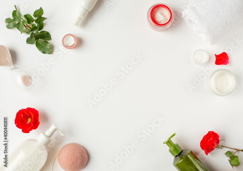 Spa and beauty. A set of organic cosmetics and red buds are located around the perimeter of the image. White background with items of natural cosmetics. Free space for text.