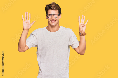 Handsome caucasian man wearing casual clothes and glasses showing and pointing up with fingers number nine while smiling confident and happy.
