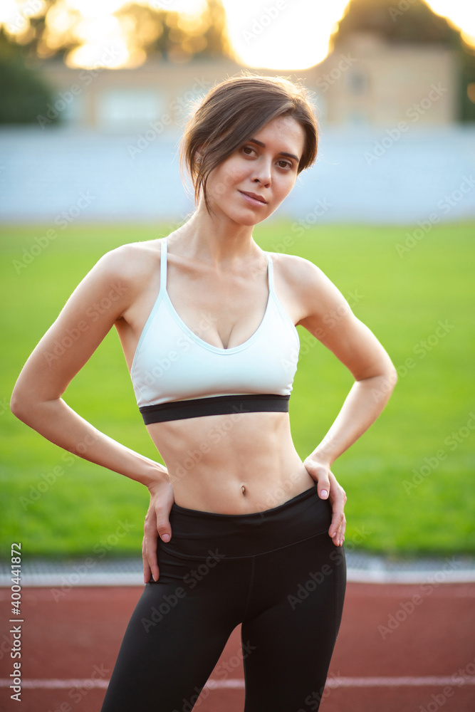 Slender woman posing at the run track Slender woman posing at the run track