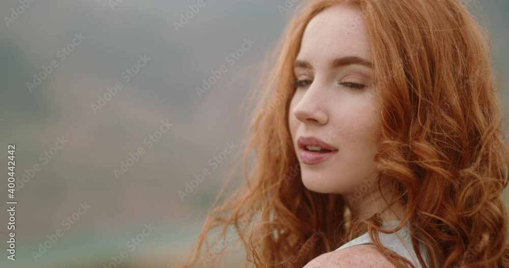 Close up shot of face of beautiful young caucasian girl with red hair ...