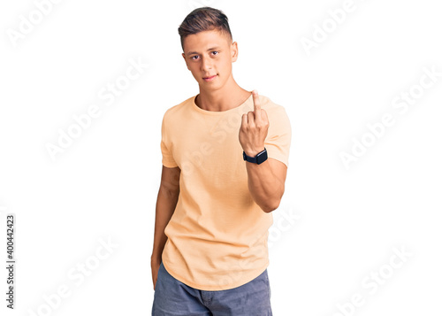 Young handsome man wearing casual clothes showing middle finger, impolite and rude fuck off expression © Krakenimages.com